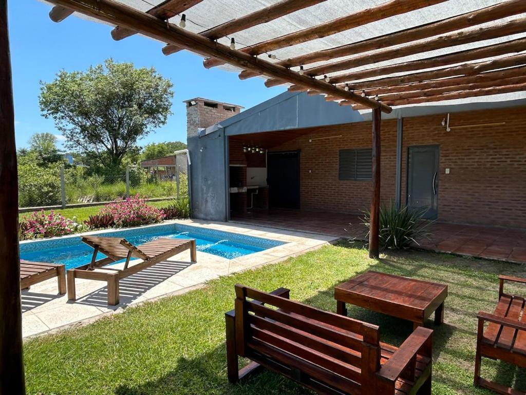 a backyard with benches and a swimming pool at Casa en Paso de la Patria in Paso de la Patria