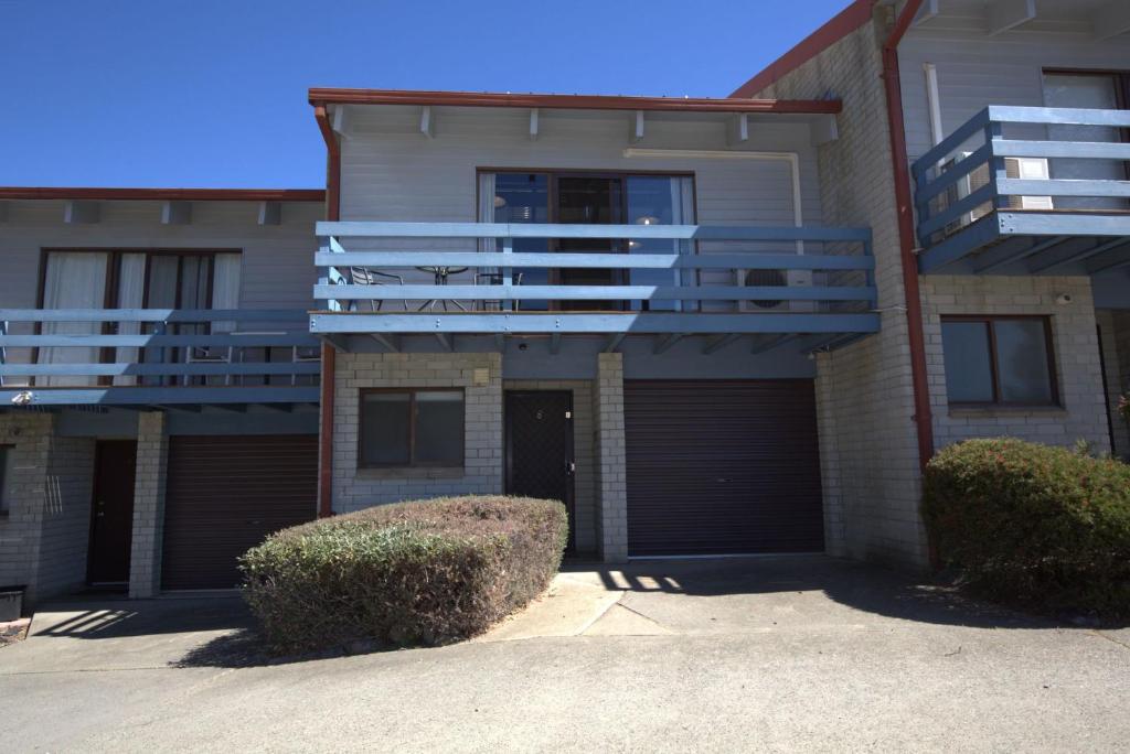 a apartment building with a garage and a balcony at Alpha Centauri - 8 - 39 Gippsland Street in Jindabyne