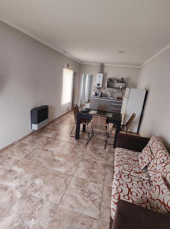 a living room with a couch and a table at Depto Civora 3 in Villa Regina