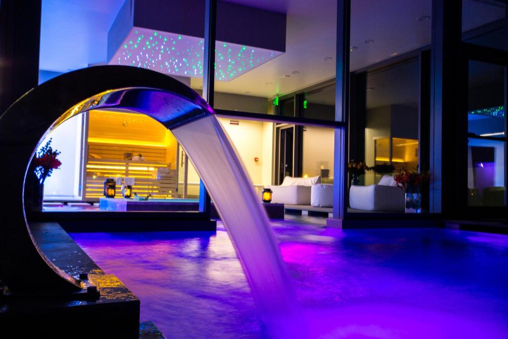 una piscina in un edificio con illuminazione viola di Hotel Abano Astoria ad Abano Terme