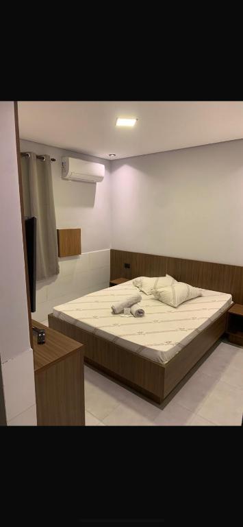a bedroom with a large bed in a room at Hotel Maya in São Paulo