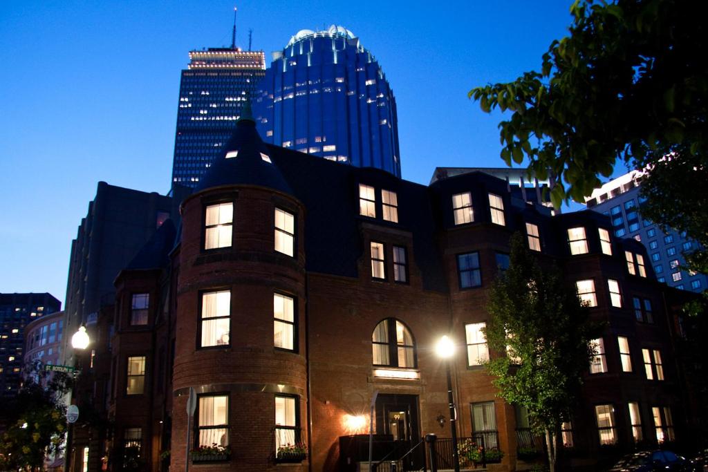 a building with lights on in a city at night at Inn at St. Botolph in Boston