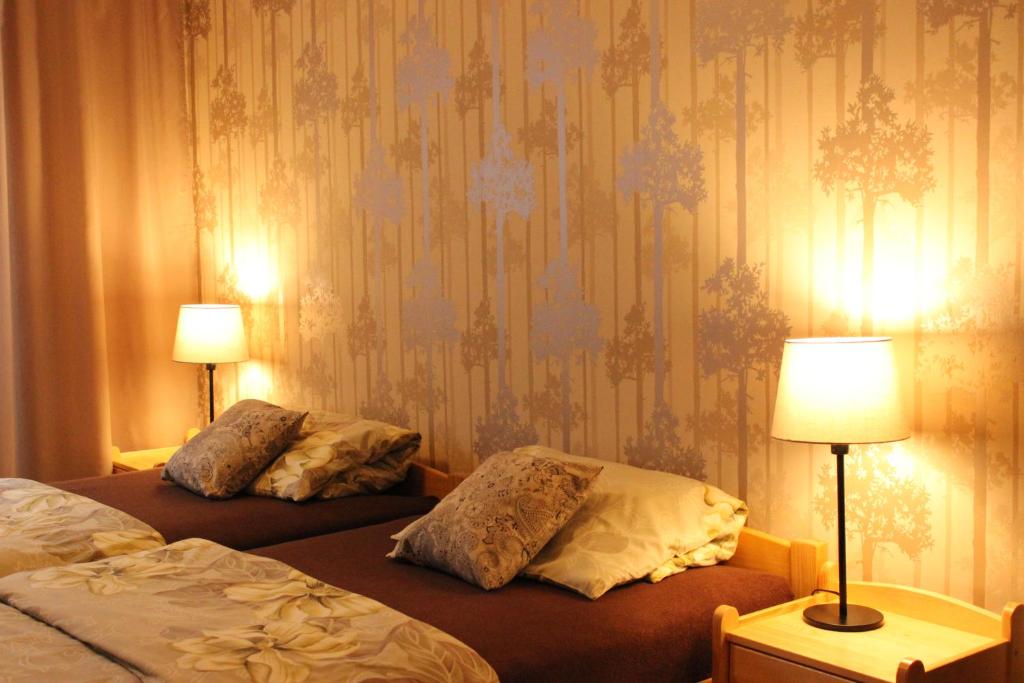 a hotel room with two beds and two lamps at Ubytování U Morisse in Staré Město