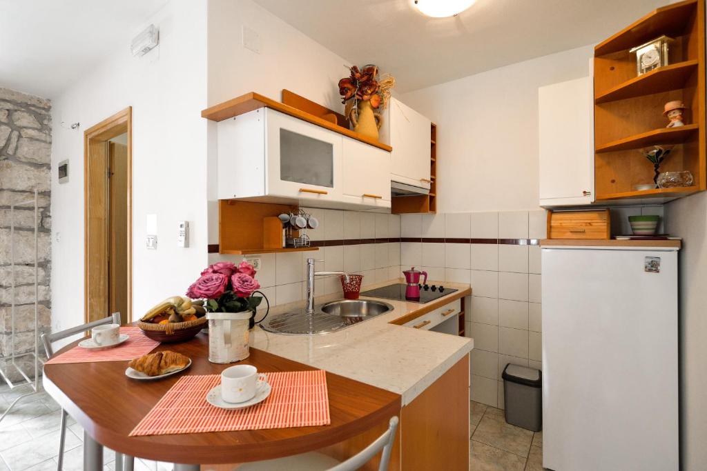 a small kitchen with a table and a sink at Apartment Julia in Nedeščina