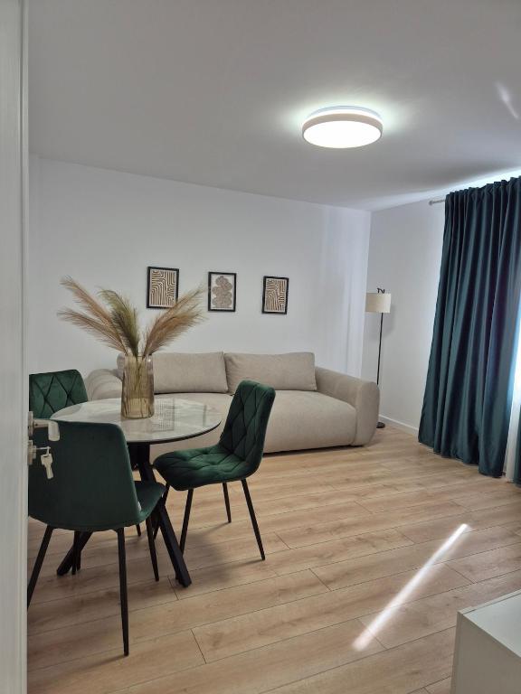 a living room with a couch and a table and chairs at D&D Central Apartment in Tulcea