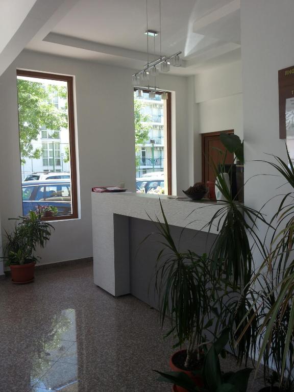 a room with a counter with potted plants in it at Family Hotel Golden Lion in Primorsko
