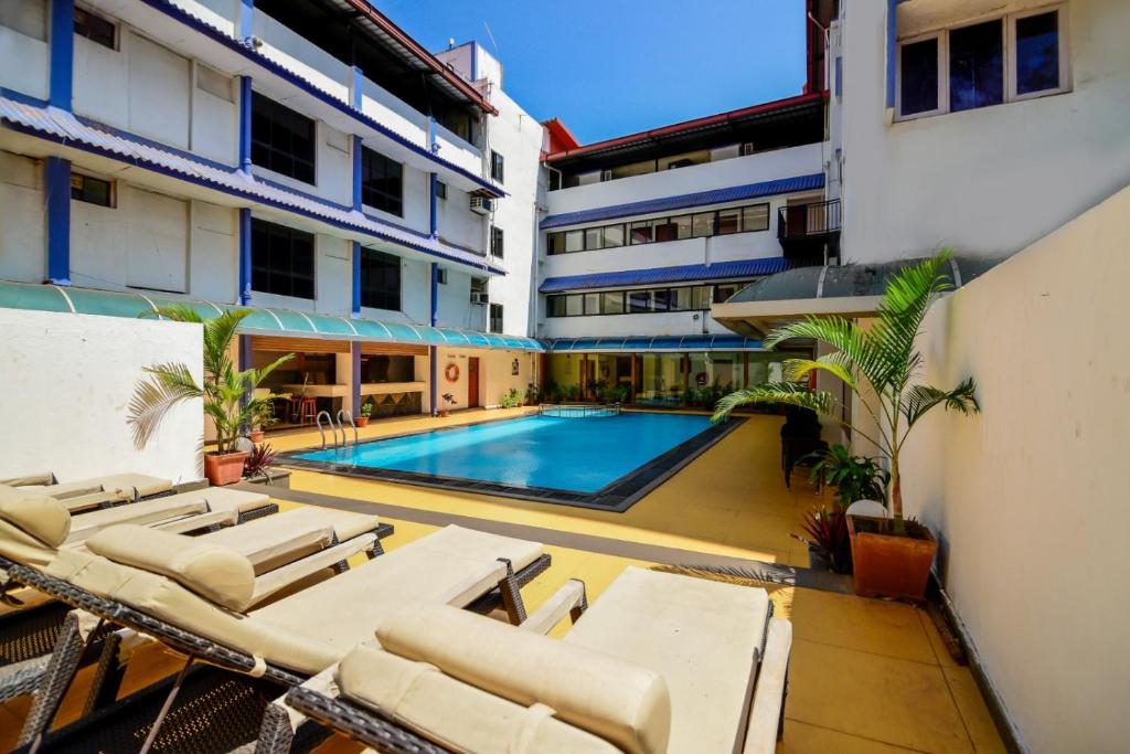 a swimming pool in the middle of a building at La-Paz Gardens Beacon Hotel - Vasco da Gama Goa in Vasco Da Gama