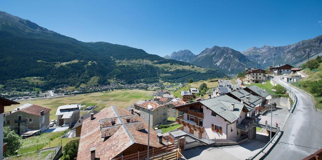 a village in the mountains with a road at Appartamenti Gallo Cedrone in Valdisotto