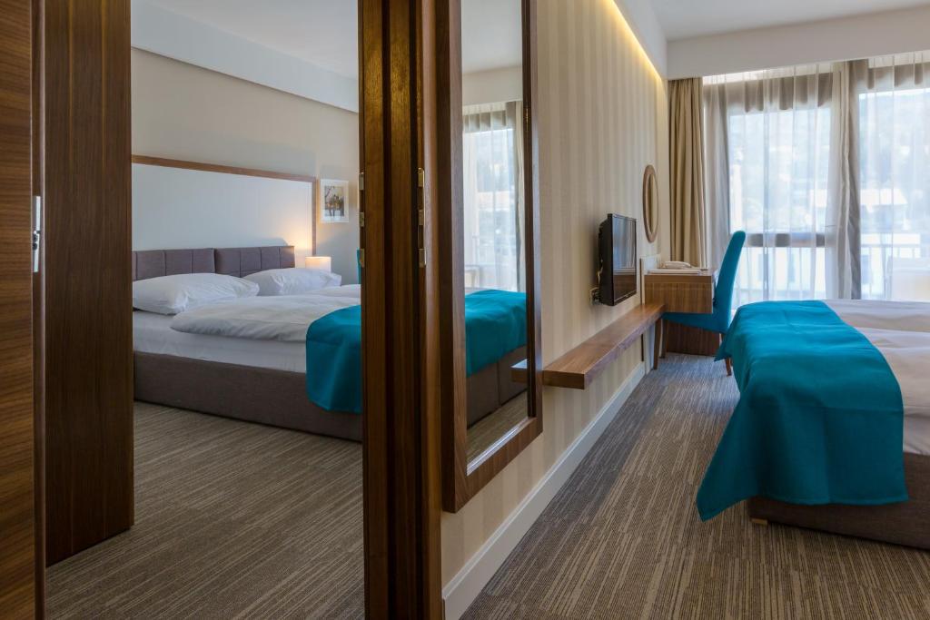 Een bed of bedden in een kamer bij Hotel Katarina