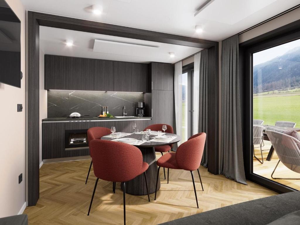 a kitchen and dining room with a table and chairs at Austria Parks - Camping Arlberg GmbH in Pettneu am Arlberg
