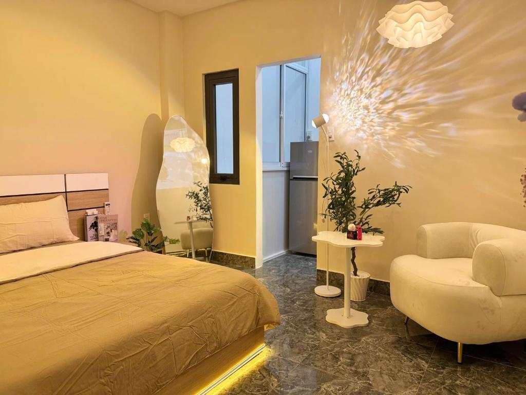 a bedroom with a bed and a chair at Four P Stay Phu Nhuan in Ho Chi Minh City