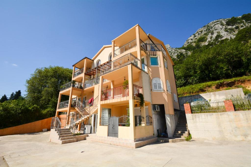 a large building with stairs on the side of it at Apartments Panorama in Kotor
