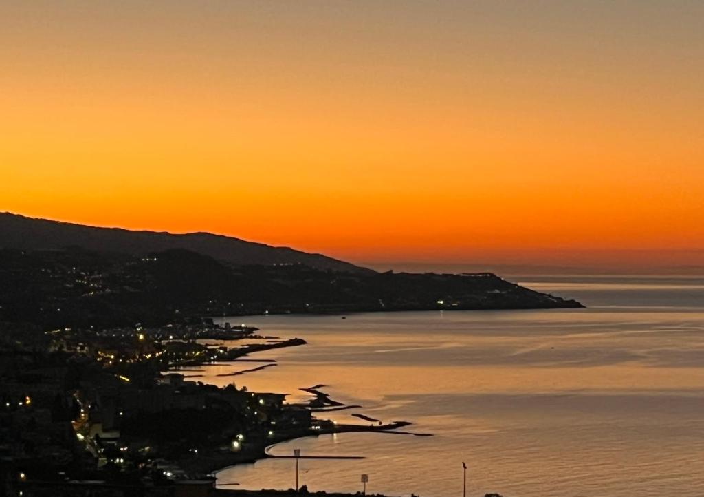 a view of the ocean at sunset at La Casa di Pucci Sanremo in Sanremo