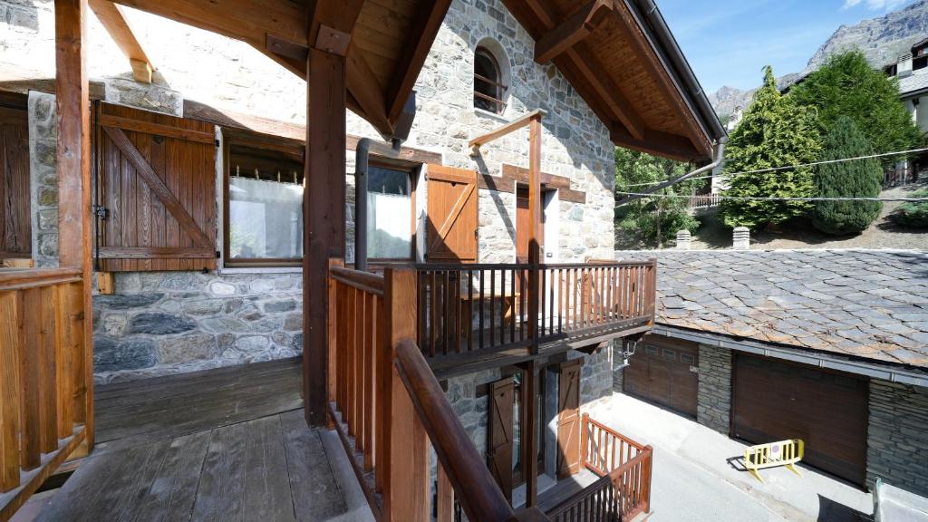 a balcony of a house with wooden railings at Chalet del Borgo in Valtournenche