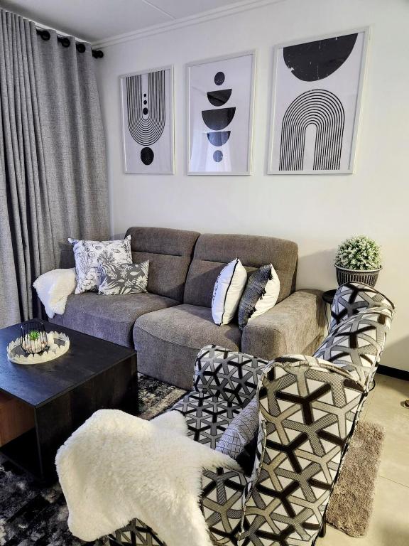 a living room with a couch and a table at Urban Contempo Lush in Fourways