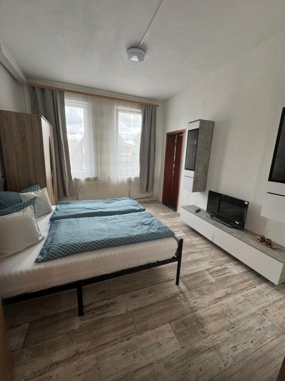 a bedroom with a bed and a television in it at Apartments Mykonos in Braunlage
