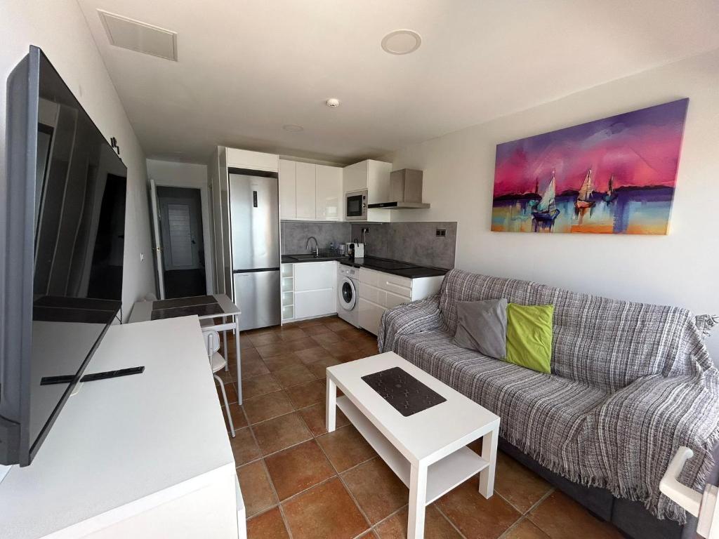 a living room with a couch and a table at Granada I Apartment 11 - Patalavaca in Patalavaca