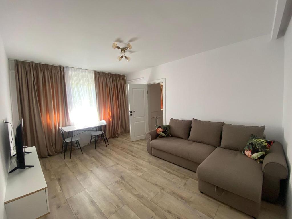 a living room with a couch and a table at LCB Apartments G Enescu 19 in Suceava