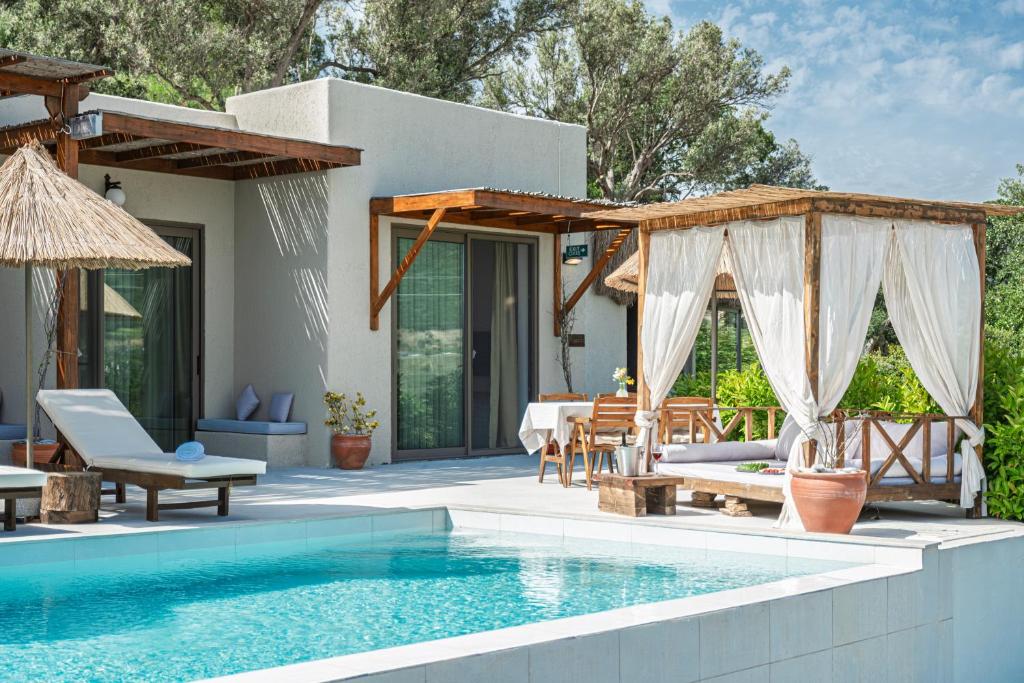 a villa with a swimming pool and a patio at South Side Bodrum in Gökçebel