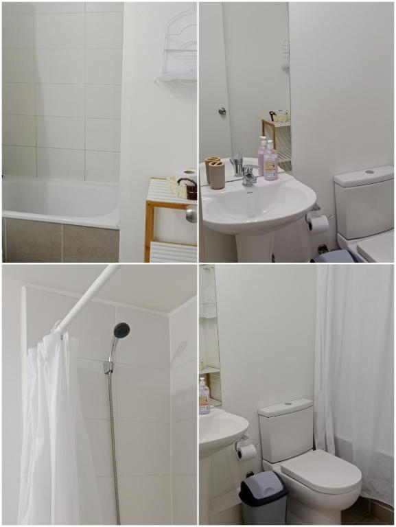 a white bathroom with a toilet and a sink at Acogedor departamento en Villa Alemana in Villa Alemana