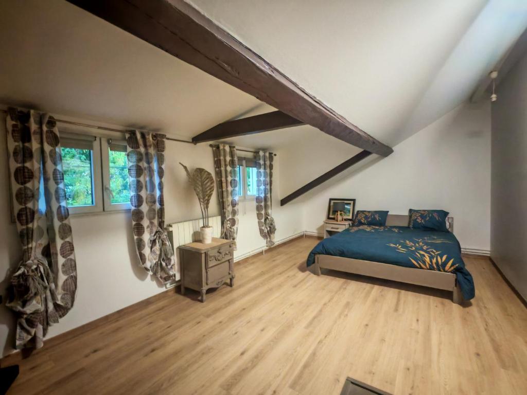 a bedroom with a blue bed and wooden floors at Nice studio in Paris suburbs in Épinay-sur-Seine