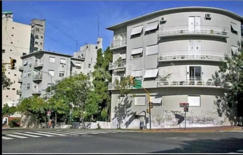 a large white building on the side of a street at ATLAS - San Telmo in Buenos Aires