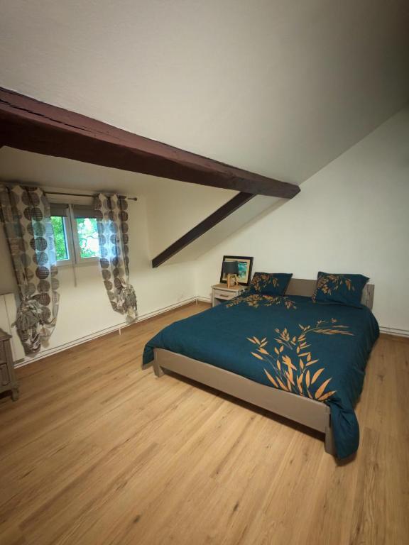 a bedroom with a large bed in a room at Independent studio in house - Paris suburbs in Épinay-sur-Seine