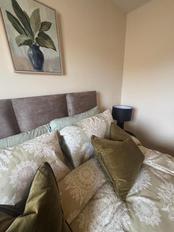 a bed with pillows on it in a room at Number Sixteen in Kildary
