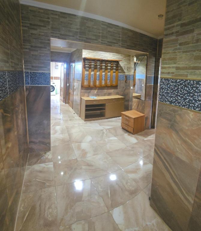 a bathroom with a large marble floor and a mirror at Хостел Твій Дім в Пирятині in Pyryatyn