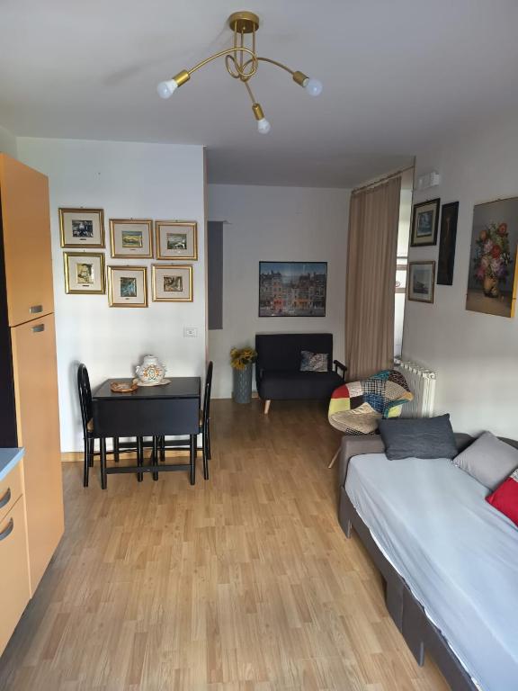a living room with a bed and a table at Come a Casa in Caserta