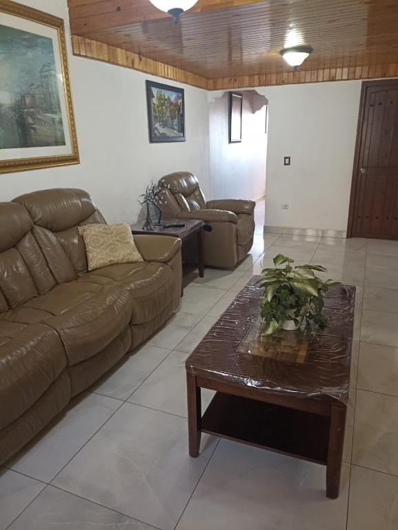 a living room with a couch and a coffee table at Casa Santa Fe Colonia Santa Fe Tijuana BC in Rancho La Gloria