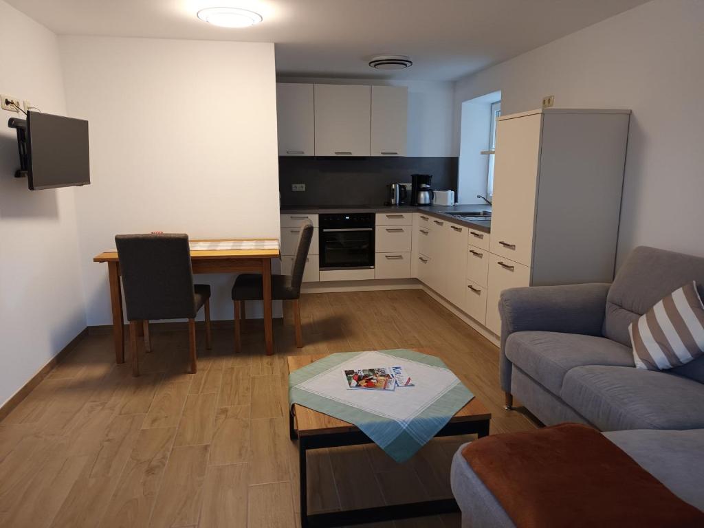 a living room with a couch and a table at Haus Barbara in Bad Füssing