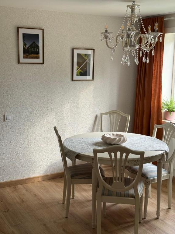 a dining room with a table and chairs at White Sand Studio in Pāvilosta