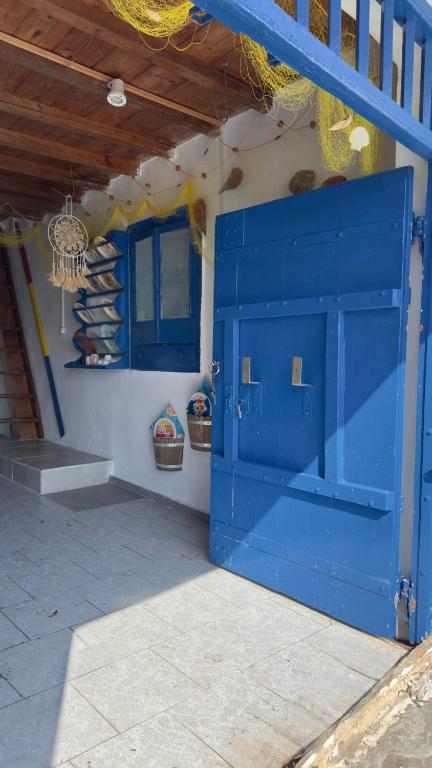 a blue door in the side of a building at Syrma Sunset Areti in Kástron