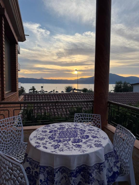 a table and chairs on a balcony with a view of the water at Seid Apartments Radhime in Vlorë