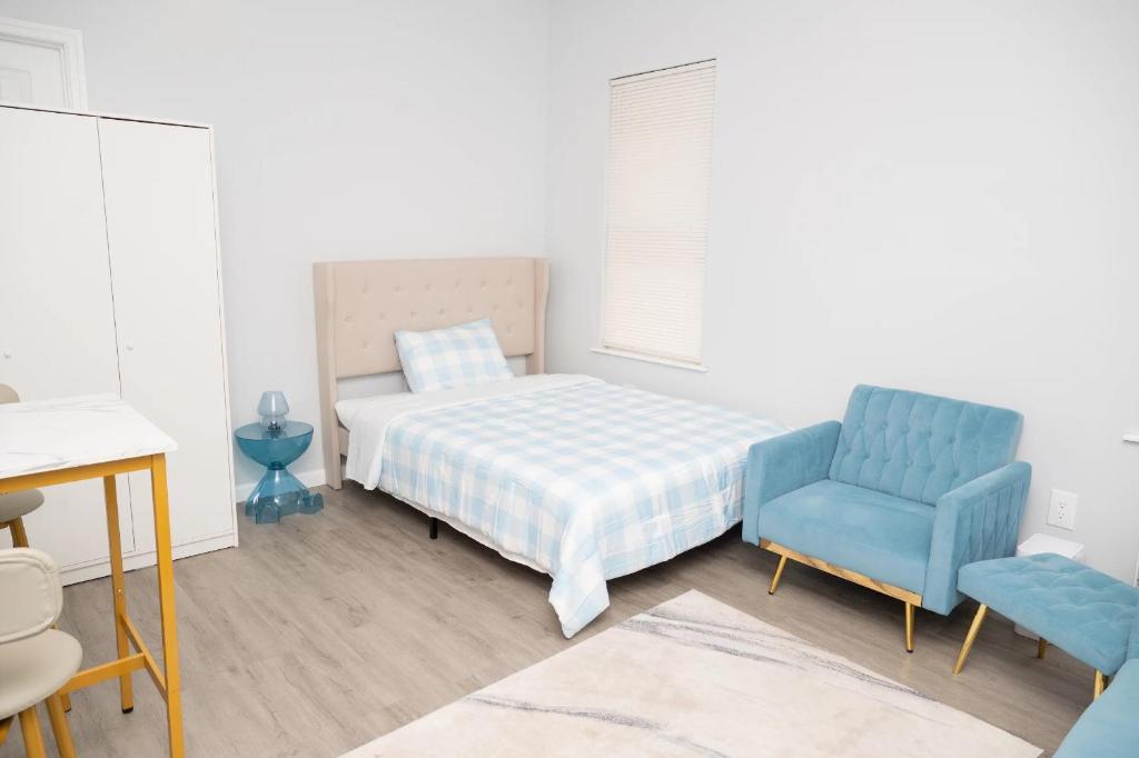 Un dormitorio con una cama y una silla azul. en Brighton Beach Retreat Blue30, en Brooklyn