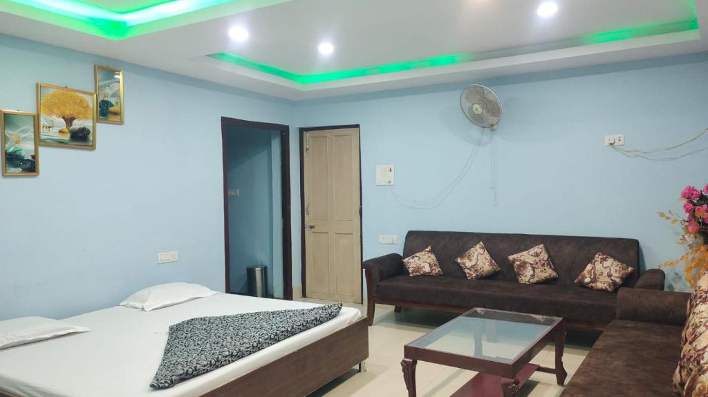 a living room with a bed and a couch at Aaam Mahua Marriage Garden in Muzaffarpur