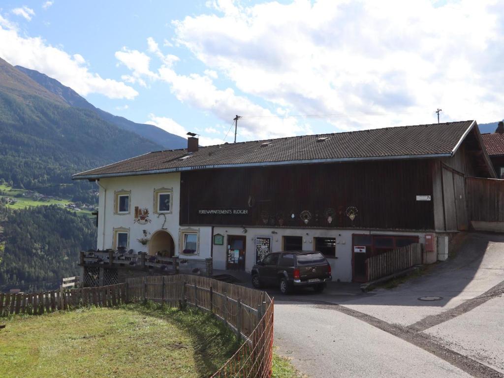 a building with a car parked in front of it at Gmarerhof in Grins