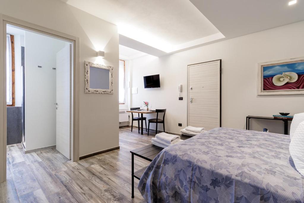 a bedroom with a bed and a living room at Loftino42 - Monolocale Open Space a Ferrara, Biciclette incluse in Ferrara