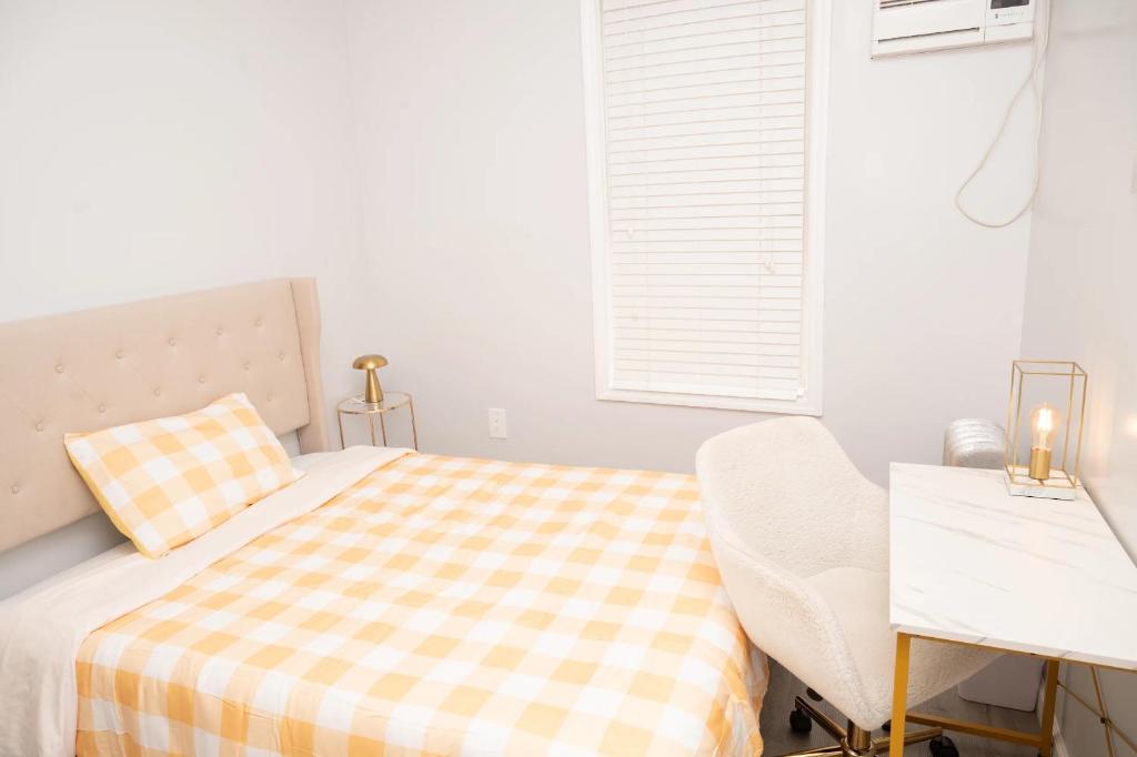 a white bedroom with a bed and a desk at Beachh - 2Beach House - Yellow3090 in Brooklyn
