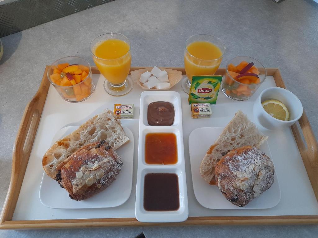 a tray of food with breakfast foods and drinks at Chabas Studio in Lagarrigue