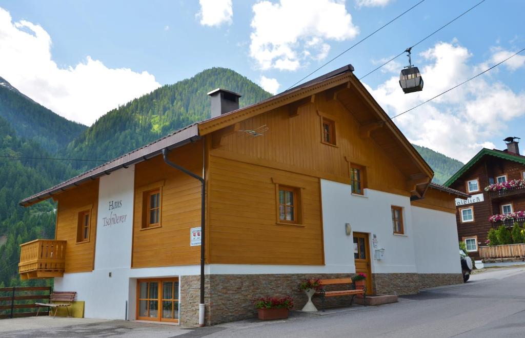 a large wooden building with a ski lift at Haus Tschiderer in Kappl