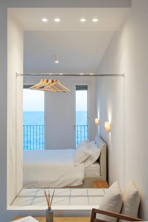 a bedroom with a bed with a view of the ocean at Trame Suites in San Vito Chietino