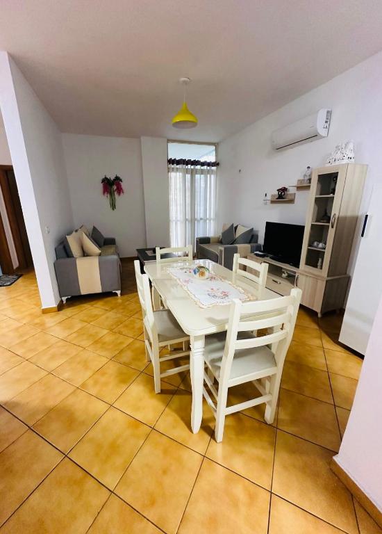 a living room with a white table and chairs at Golem Beach Apartment - Very Large - Self Check In - Parking Available in Golem