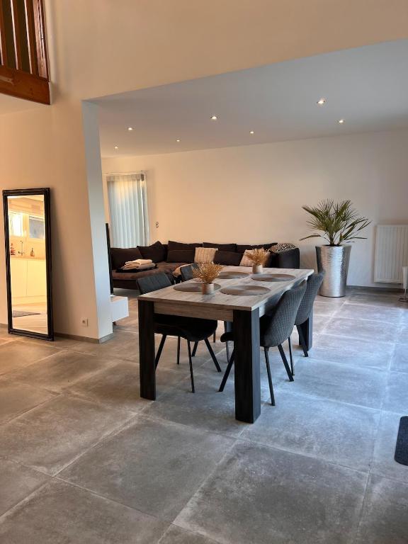 a living room with a table and a couch at Maison Lesve in Profondeville
