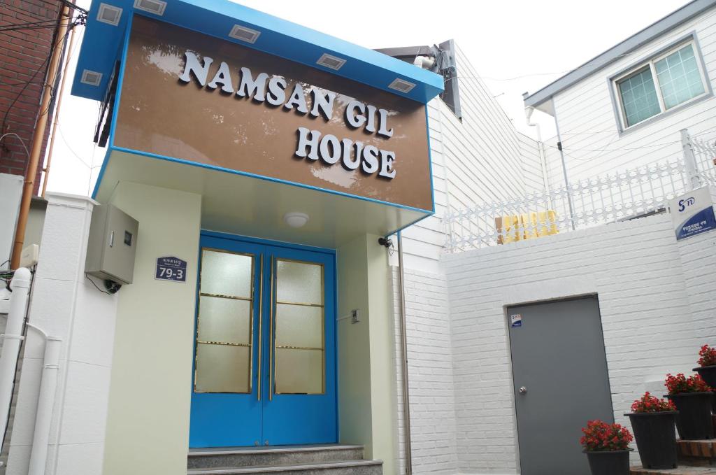 a house with a blue door and a sign on it at Namsan Gil House in Seoul