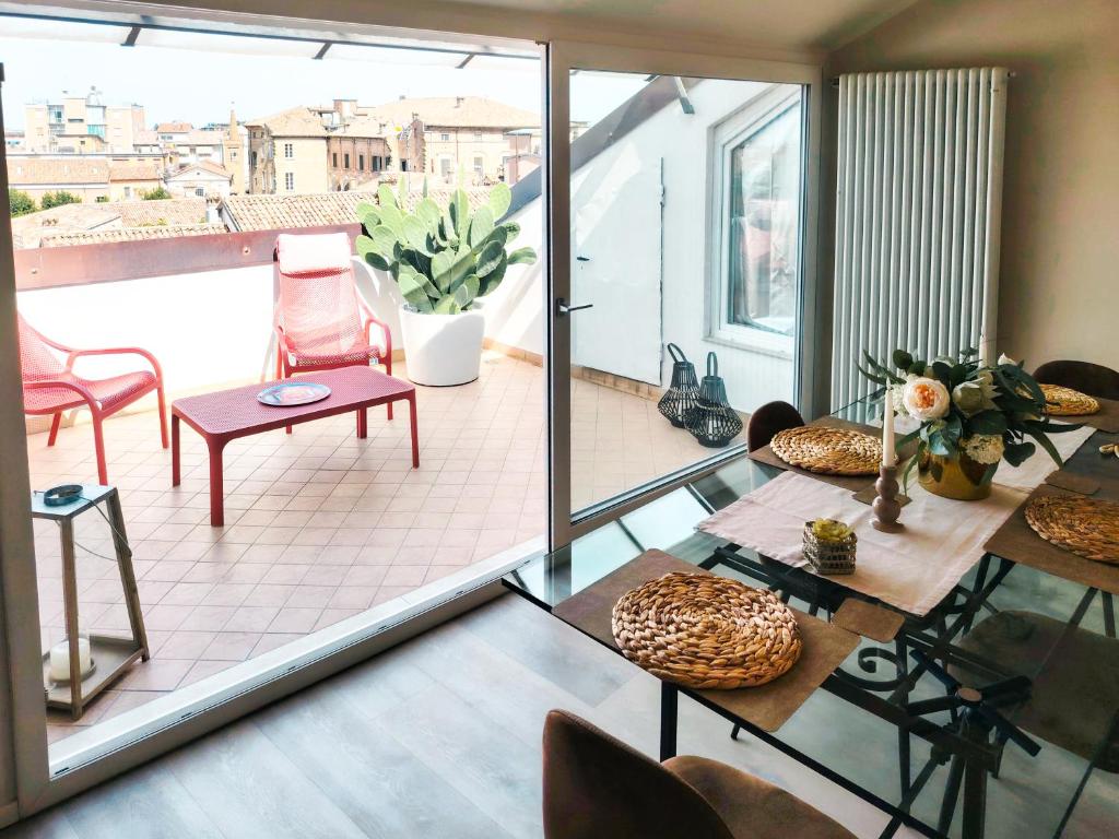 a room with a balcony with a table and chairs at Bellavista Deluxe in Cesena