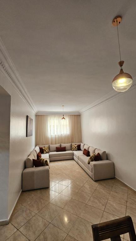 a large living room with two couches and a table at Jad Appartement N1 in Essaouira