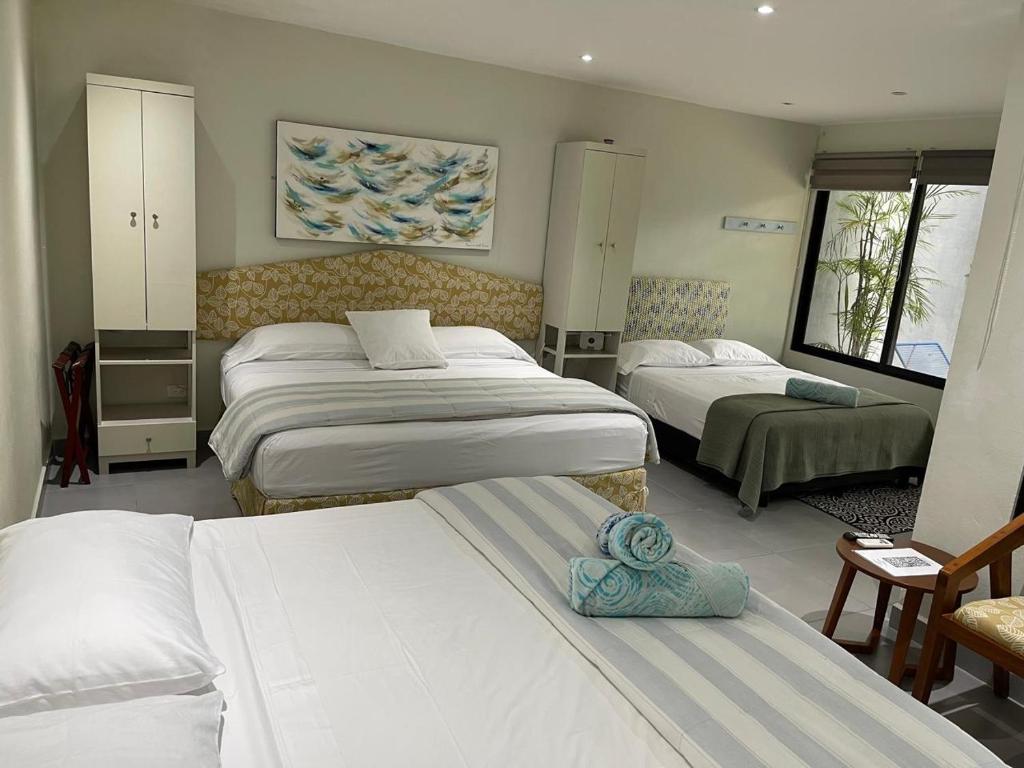 a hotel room with two beds and a room with at The Blue Eco Lodge in Valladolid