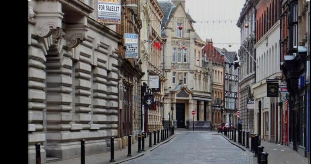an empty street in a city with buildings at Hull Central Comfort in Hull
